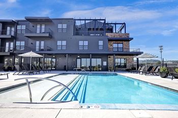 Resort-style rooftop pool and umbrellas at artisan flats apartments in birmingham, al